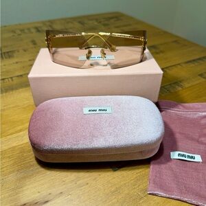 Miu Miu Runway oversized light brown sunglasses with gold accents.